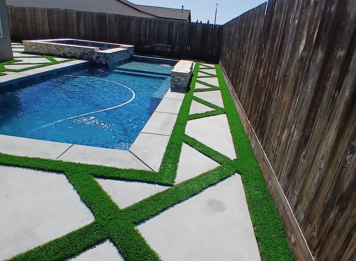 Turf strips between pool deck pavers